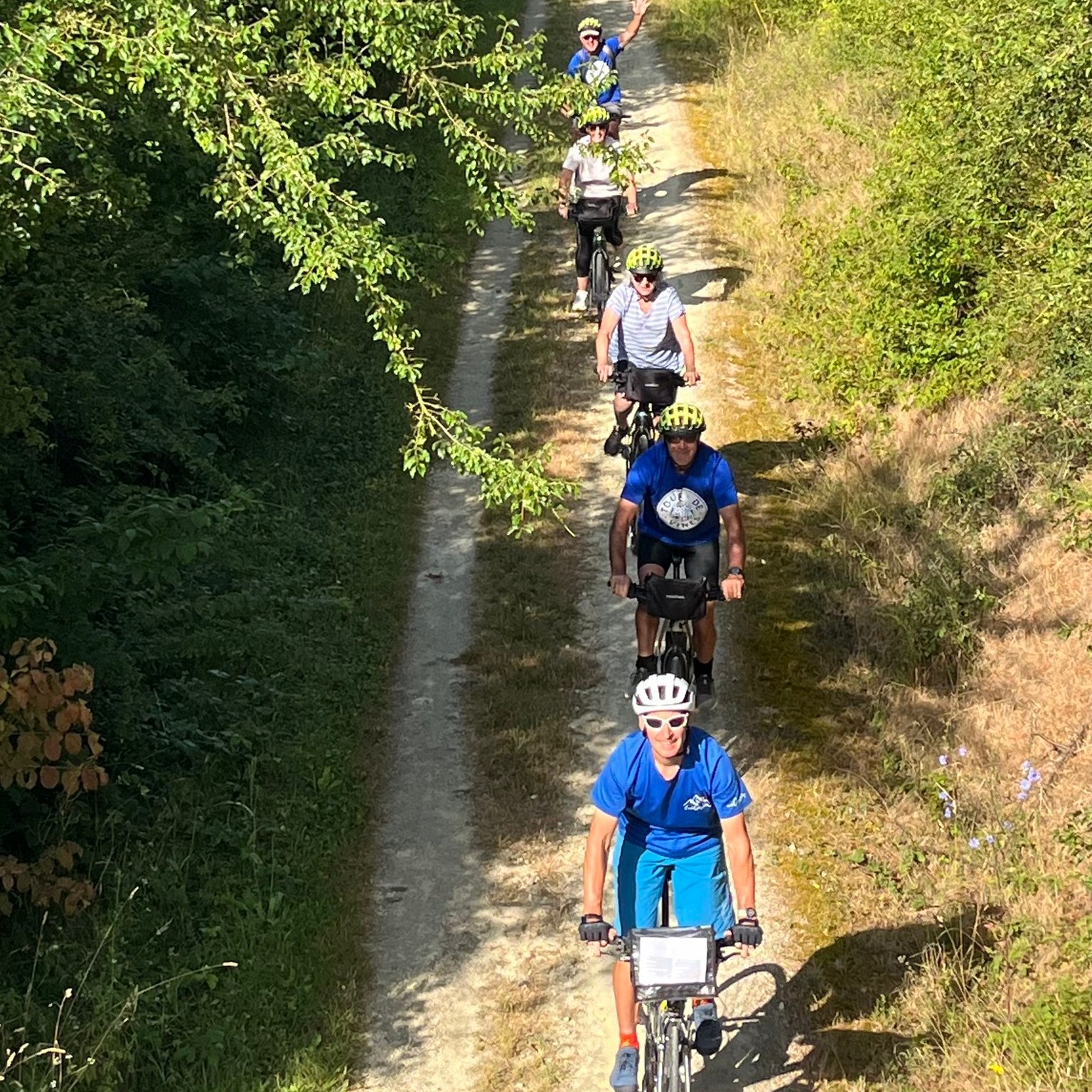 Cyclists ride along a bike trail in France, as viewed from above